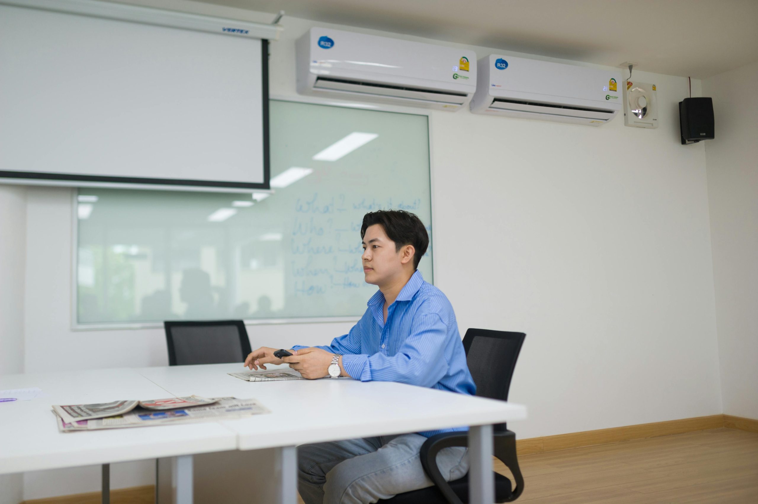 Home Businessman sits alone in modern office meeting room using technology.